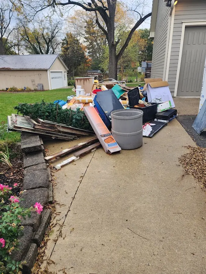 Dumpster being loaded with debris for Estate Cleanout Dumpster Rental in Mascot